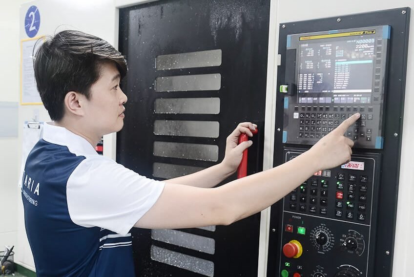 MadeAria CNC operator setting a machining center